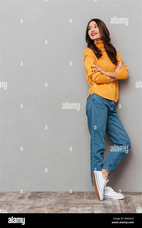 Full Length Image Of Happy Brunette Woman In Sweater With Crossed Arms