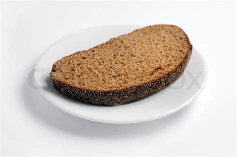 Slice Of Bread On A White Plate On A White Background Stock Photo