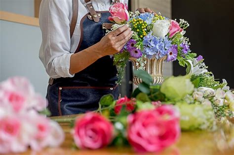 Premium Photo Midsection Of Woman Arranging Flowers In Bouquet