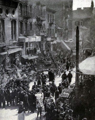 An Old Black And White Photo Of People In The Street