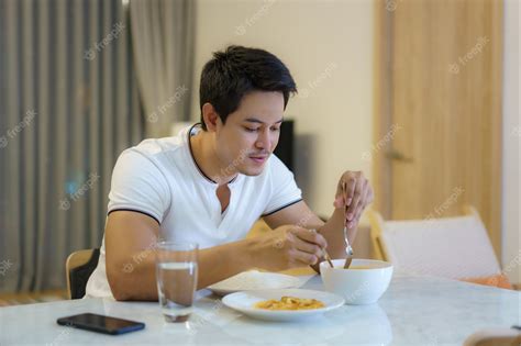 Premium Photo An Asian Man Is Eating Dinner Alone At The Dining Table