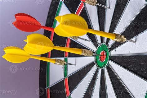 Red And Yellow Dart Arrows Hitting In The Target Center Of Dartboard