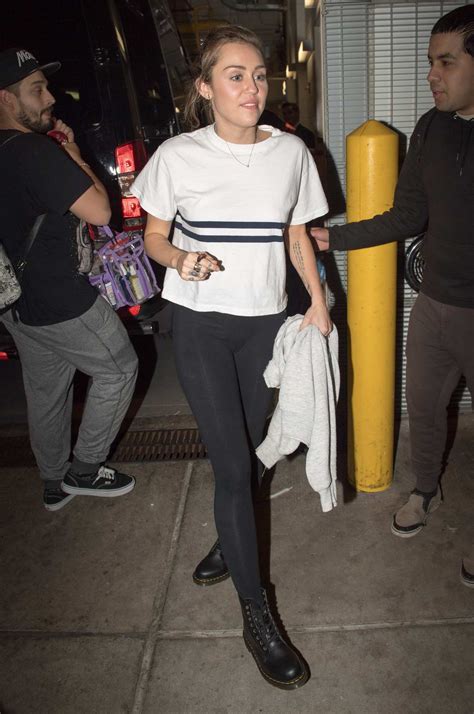 Miley Cyrus poses with her fans in New York City