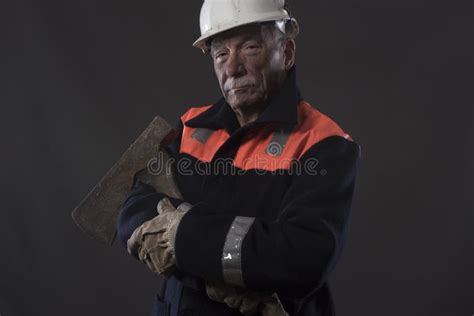 Mature Miner Covered In Coal Dust Holding A Pick Axe Stock Photo