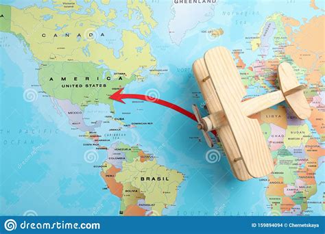 World Map With Wooden Plane And Red Arrow Pointing On Usa Royalty Free