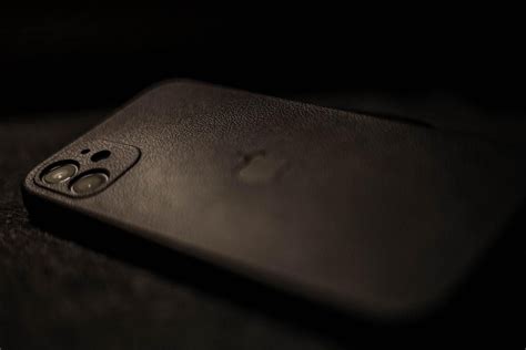 A Black Cell Phone Sitting On Top Of A Table