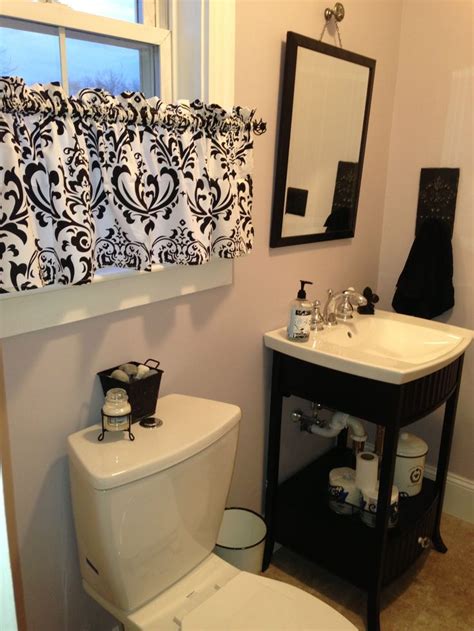 Half Bathroom With Black Vanity Featuring Sensitive Tint By Sherwin