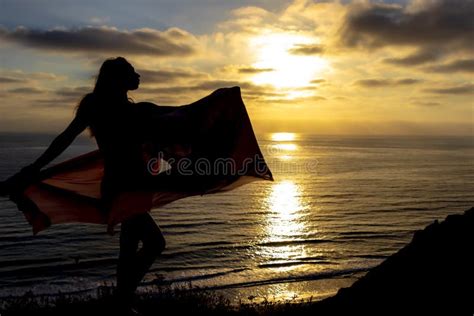 Lovely Brunette Bikini Model Relaxing On The Shoreline At Sunset Stock