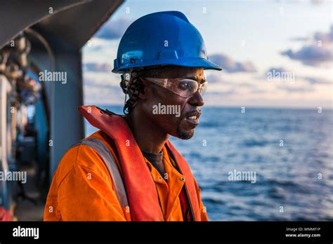 Tired Seaman Ab Or Bosun On Deck Of Vessel Or Ship Wearing Ppe Personal Protective Equipment