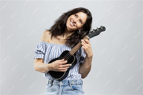 Premium Photo Attractive Brunette Woman Playing Ukulele Isolated On