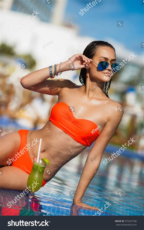 Tenned Beautiful Woman Orange Bikini Sunlasses Stock Photo