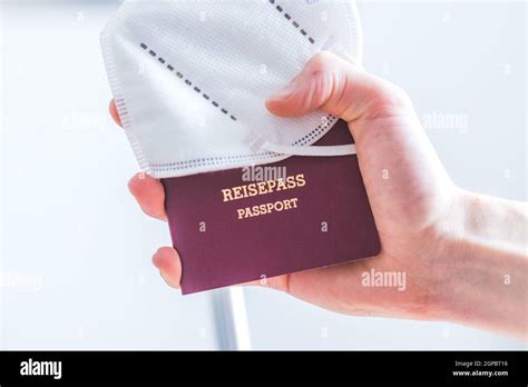 Close Up Of Fingers Holding A Passport For Travelling Airport