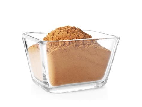 Premium Photo Bowl With Aromatic Cinnamon Powder On White Background