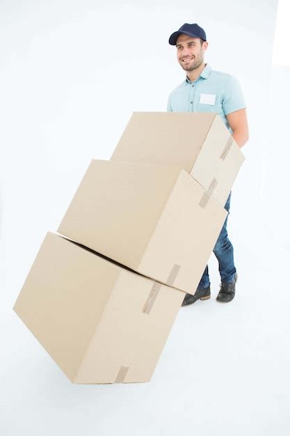 Premium Photo Happy Delivery Man Pushing Trolley Of Boxes