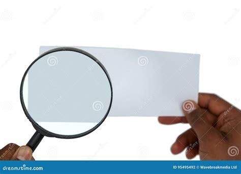 Close Up Of Man Holding Magnifying Glass On Paper Stock Photo Image