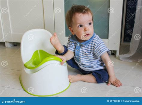 A Little Boy Learns To Go Potty Accustom The Child To The Potty Stock