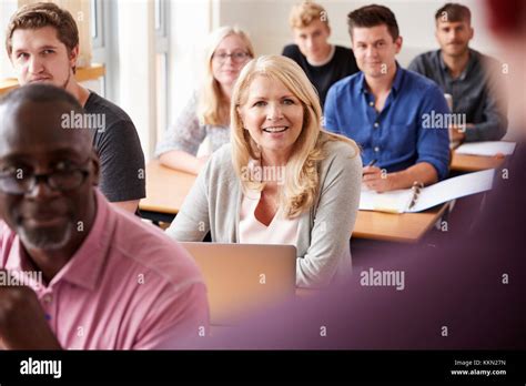 Male Tutor Teaching Class Of Mature Students Viewed From Behind Stock Photo Alamy