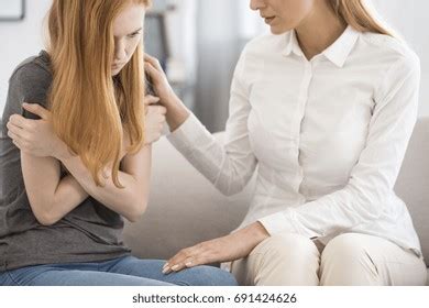 Female Professional Psychologist Comforting Upset Woman Stock Photo