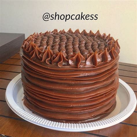 A Large Chocolate Cake Sitting On Top Of A White Plate