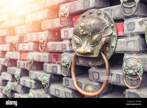 Ancient Iron Lions Head Door Knocker Situated On A Brick Wall China