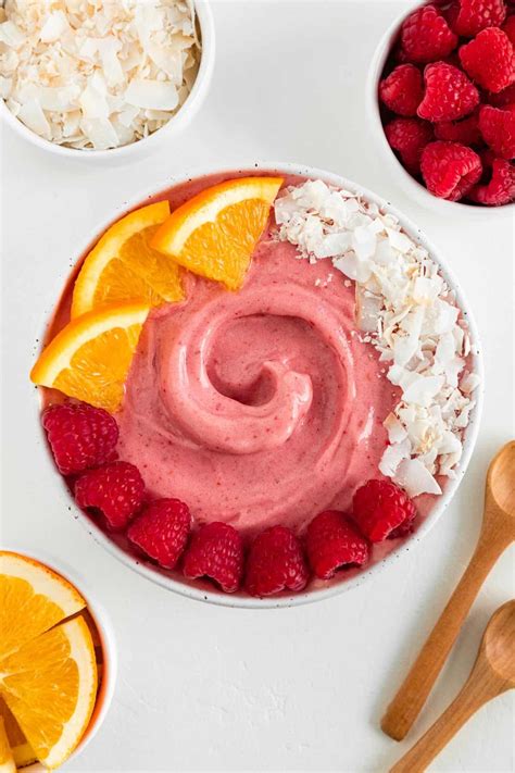 A Bowl Filled With Fruit Next To Bowls Of Rice Oranges And Raspberries