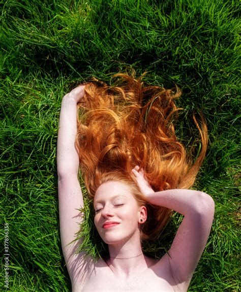 Portrait Of A Beautiful Young Sexy Red Haired Woman Lying In The