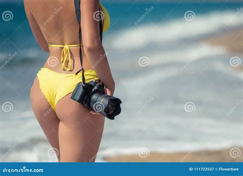 Beautiful Female Photographer With Professional Camera On The Beach Background Naked Woman In