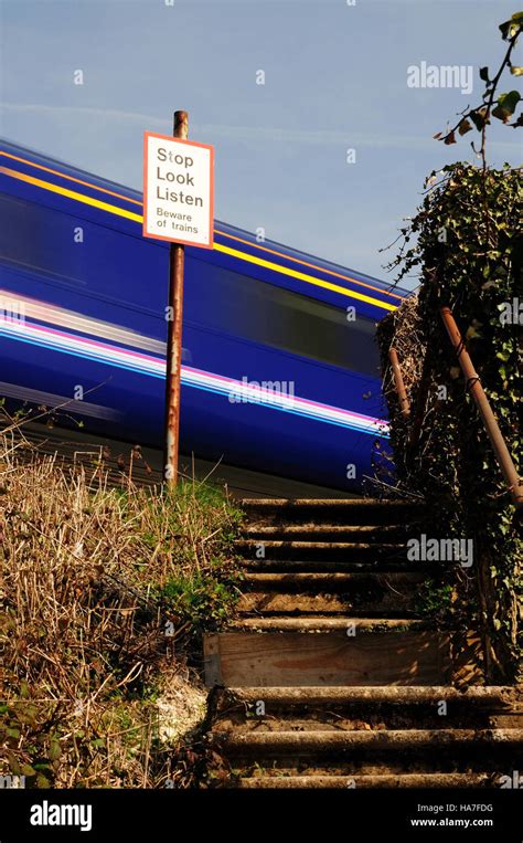 A High Speed Train Passing Over A Footpath Crossing Stock Photo Alamy