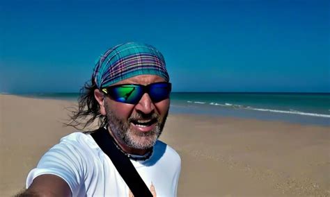 Premium Photo Portrait Of Mature Man Wearing Sunglasses Standing At Beach