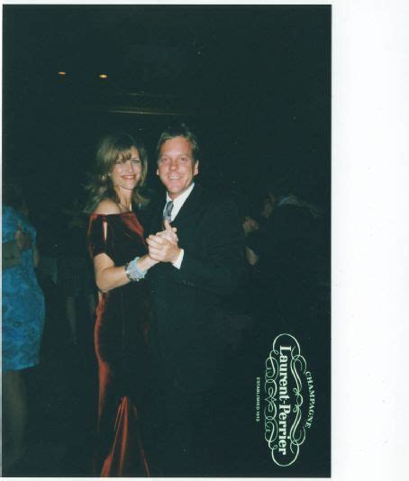 a man and woman are dancing together at a formal event with other ...