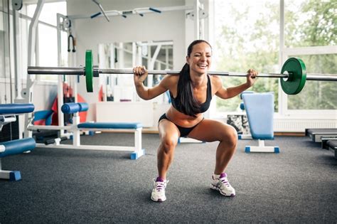 Premium Photo Fitness Woman Doing Squats With Barbell