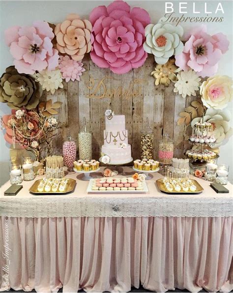 A Table Topped With Lots Of Cakes And Desserts Next To A Wall Covered