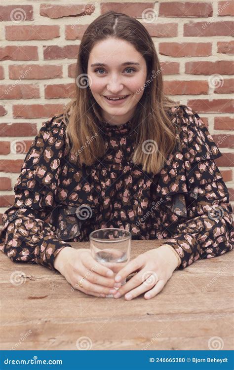 Beautiful Smiling Young Woman Holding A Glass Of Pure Water In Morning