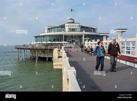 Tourists On Seaside Pier Along The North Sea Coast At Blankenberge