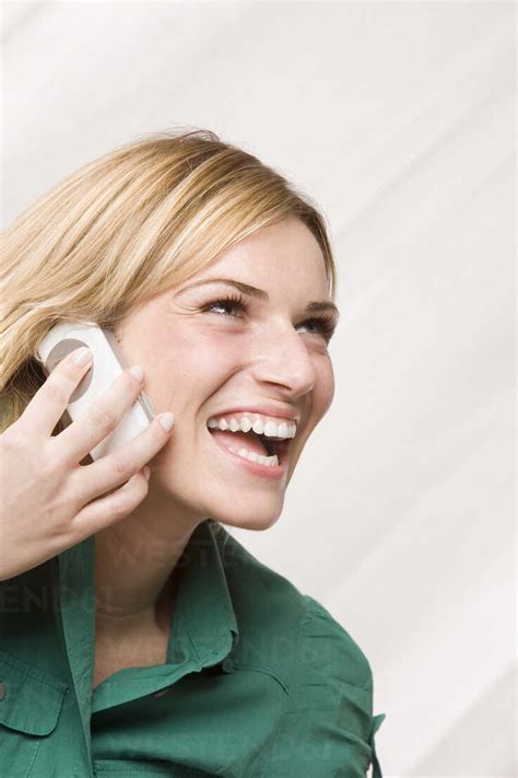 Blonde Woman Using Mobile Phone Laughing Portrait Stock Photo