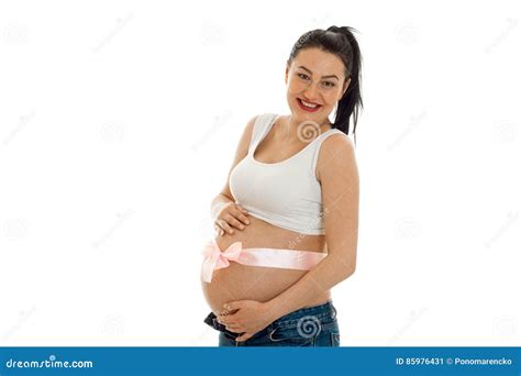 Cheerful Pregnant Brunette Woman With Pink Tape On Her Big Belly Posing