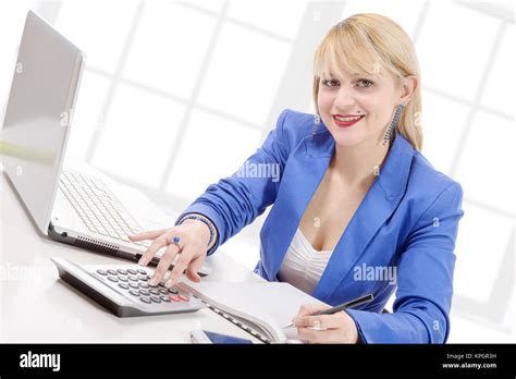 Attractive Blonde Secretary Sitting At Her Desk Stock Photo Alamy