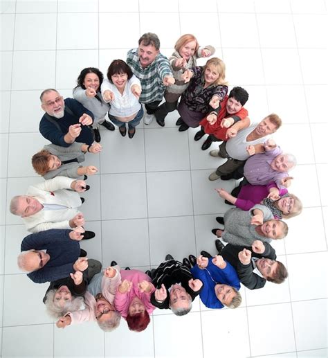 Premium Photo Group Of Smiling Mature People Pointing At You