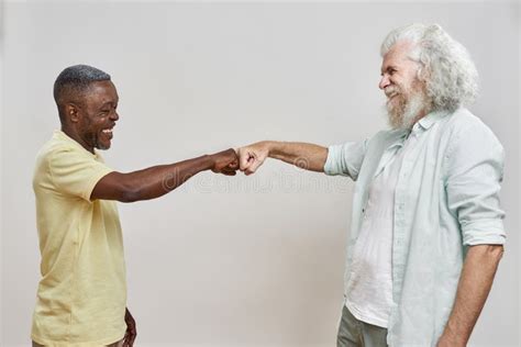 Side View Of Mature Multiracial Men Bumping Fists Stock Image Image Of Multiracial Together