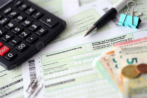 German Income Tax Return Form With Pen And European Euro Money Bills