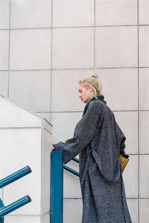 Fashionable Blonde Woman Climbing The Stairs By Stocksy Contributor