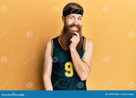 Redhead Man With Long Beard Wearing Basketball Uniform Looking