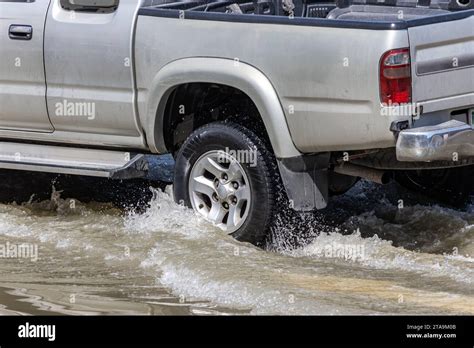 A Pickup Truck Drives Through A Flooded Street In The City Bangkok