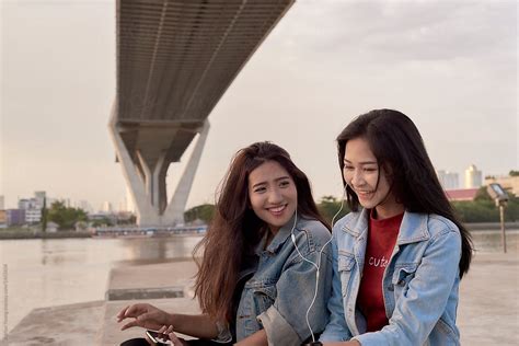 Two Friends Listening To Music Together By Stocksy Contributor