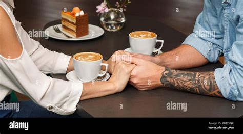 Couple Holding Hands Having Coffee In Cafe Closeup Cropped Stock