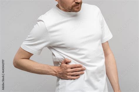 man touching sick side feeling sharp pain  ribs isolated