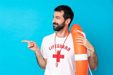 Premium Photo Lifeguard Man Over Blue Pointing Finger To The Side