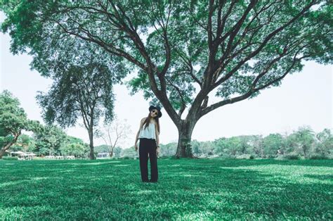 Premium Photo Portrait Of Smiling Mid Adult Woman Standing On Field