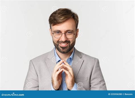 Close Up Of Bearded Businessman In Glasses And Suit Scheming Something Smiling Devious And