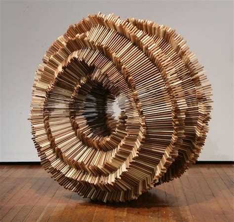 A Sculpture Made Out Of Books Sitting On Top Of A Wooden Floor